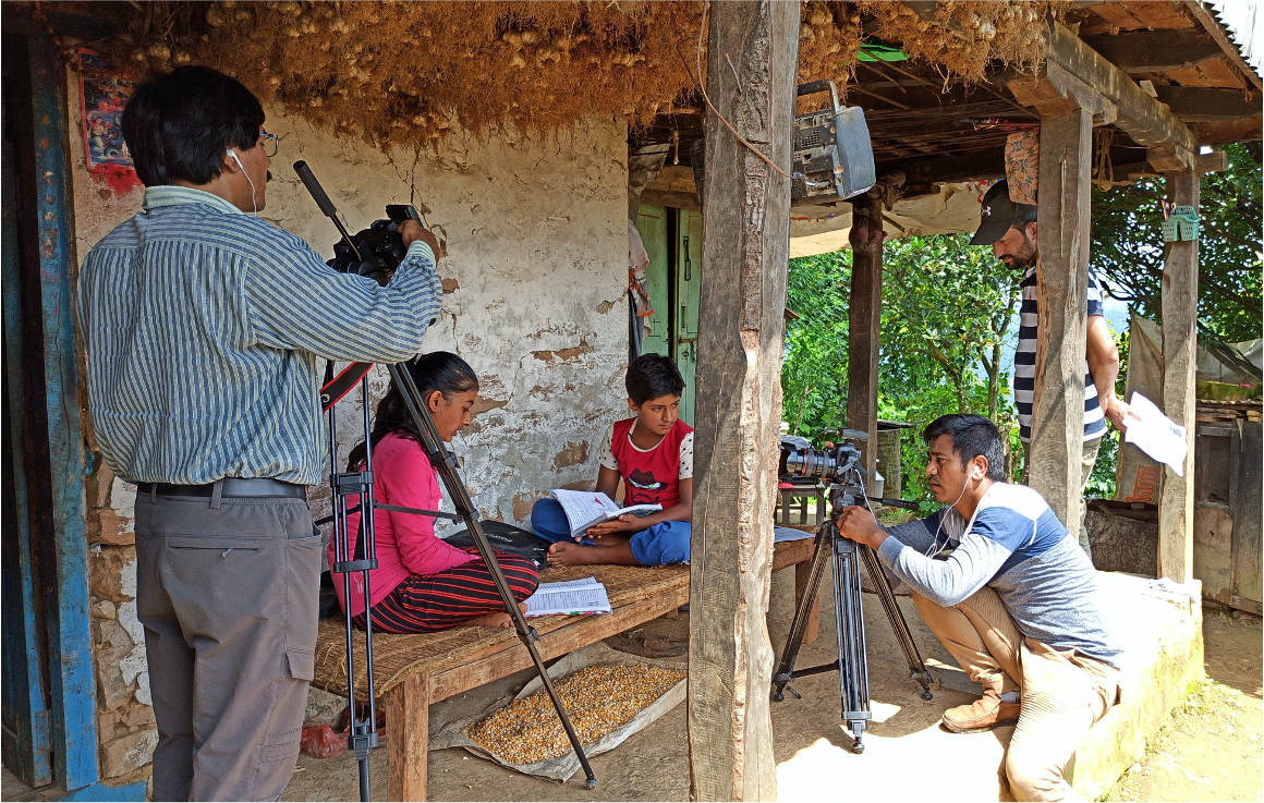 A PARC team member training youth on photography.