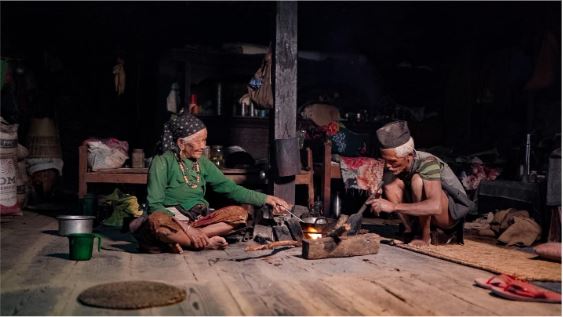 Community members around a fire, representing storytelling.