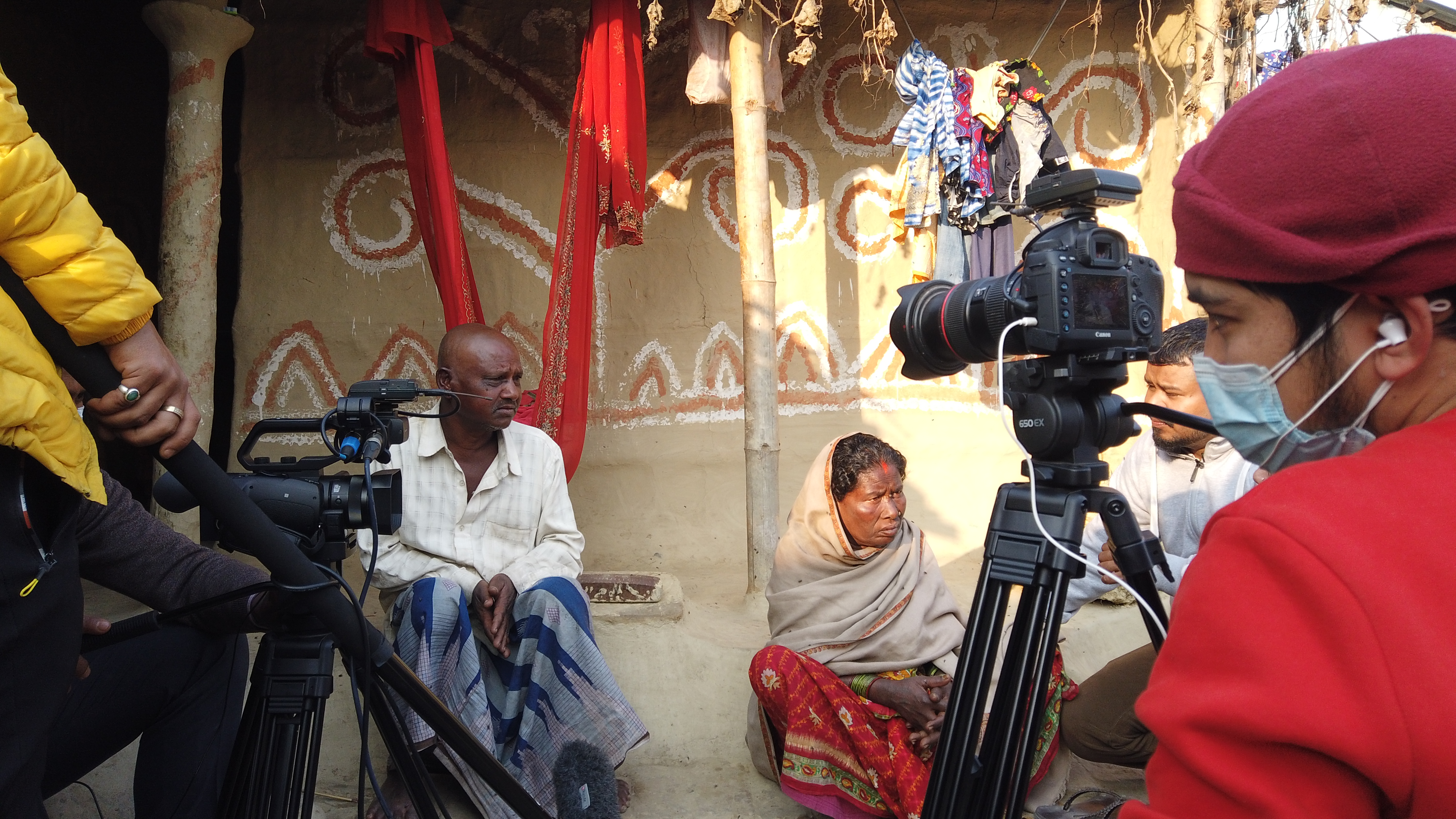 A group of community members engaging with multilingual disaster communication materials.